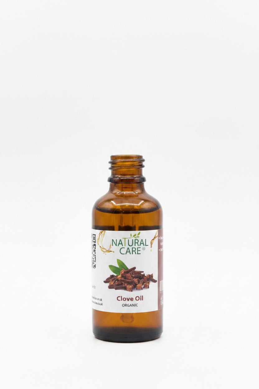Bottle of Natural Care Clove Oil on a wooden surface with blurred background