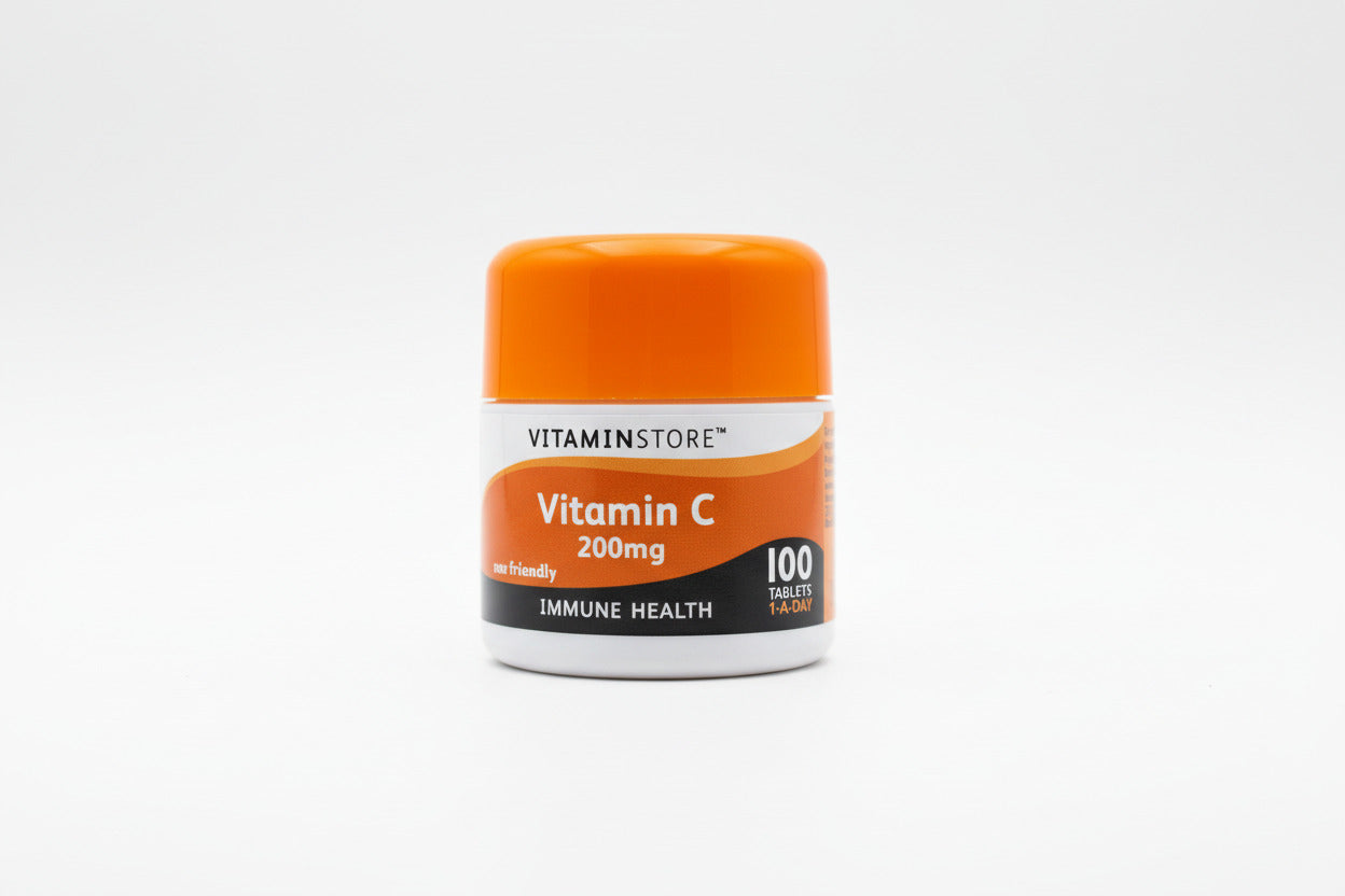 Vitamin C supplement container with orange lid on a light gray background