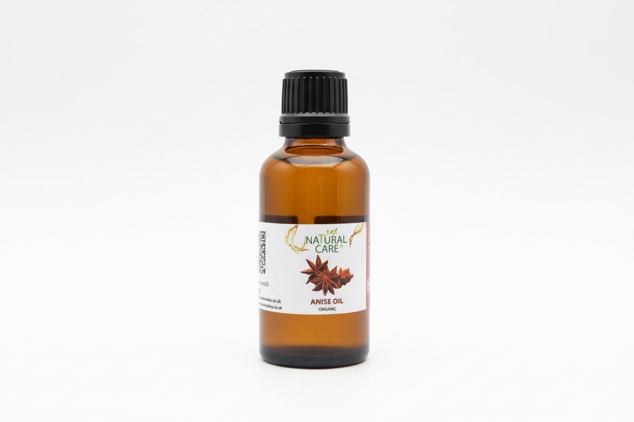 Bottle of anise oil with a 'Natural Care' label on a wooden surface