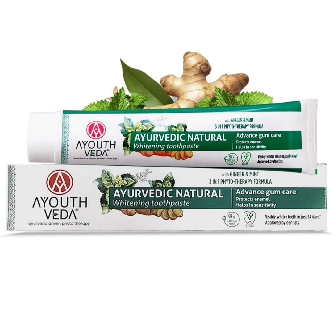Ayurvedic Natural Whitening toothpaste with ginger and mint ingredients on a white background.