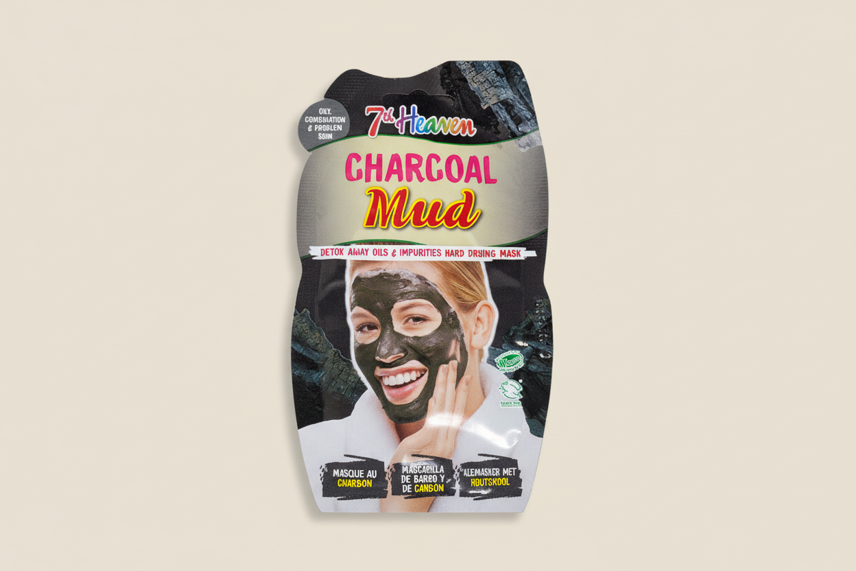 Packaging of 7th Heaven Charcoal Mud mask with a woman applying the mask.