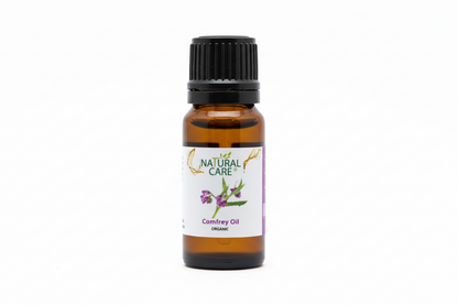 Bottle of Natural Care Comfrey Oil on a wooden surface