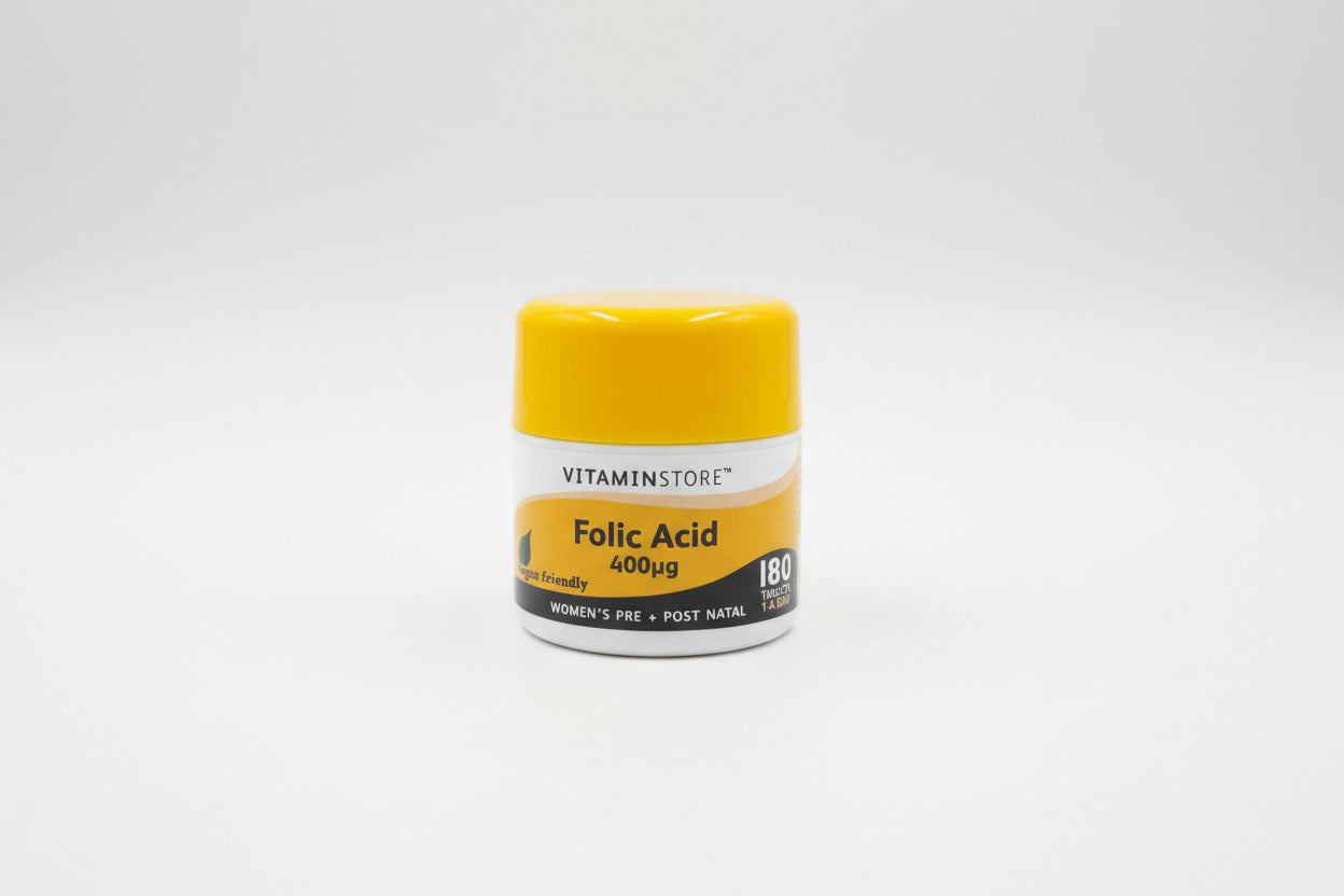 Yellow and white container of Vitaminstore Folic Acid 400εg on a light gray background