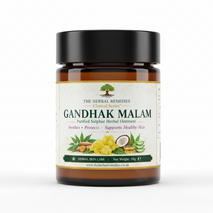 A rectangular product label for The Herbal Remedies Ghandhak Malai Purified Sulphur Herbal Ointment, featuring a white background with green, yellow, and orange illustrations of fruits and leaves, along with product details, usage, and storage instructions.