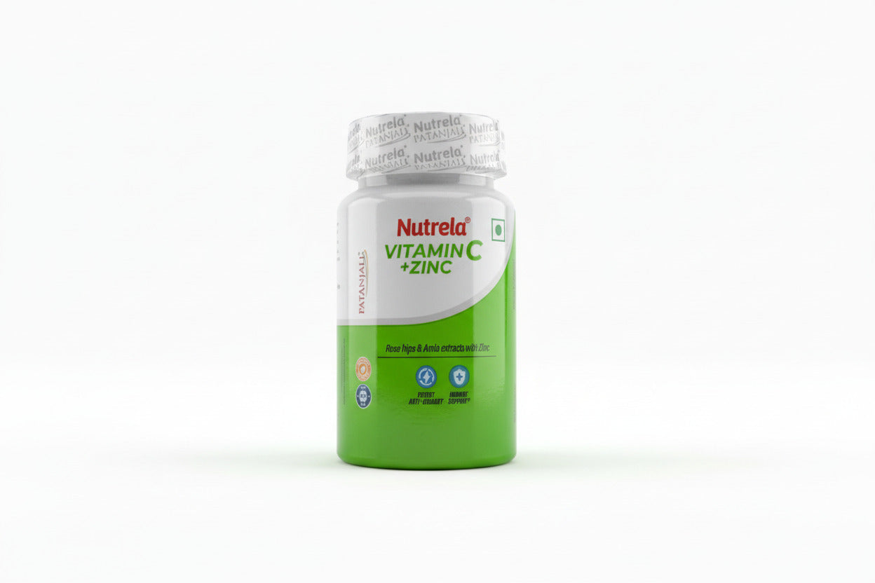 Nutrela Vitamin C + Zinc supplement bottle held by a hand on a light background