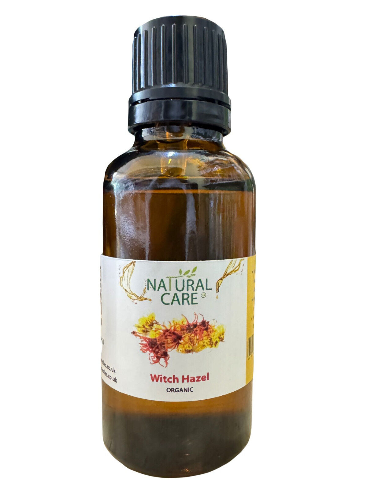 A bottle of Organic Witch Hazel Oil with a label showing the product name and an image of a witch hazel flower.