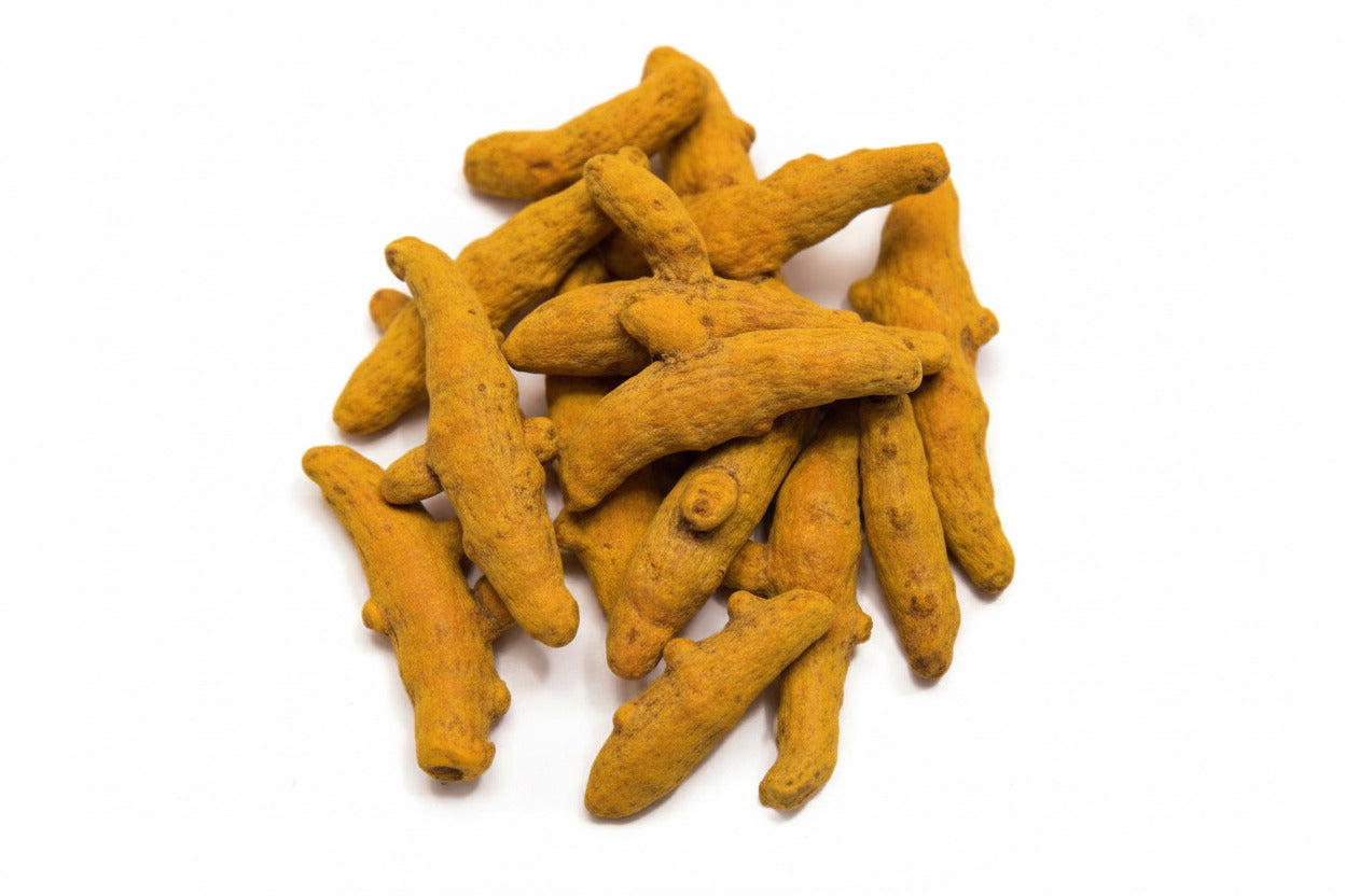 Turmeric root pieces on a white background