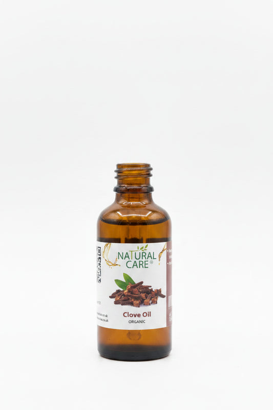 Bottle of Natural Care Clove Oil on a wooden surface with blurred background