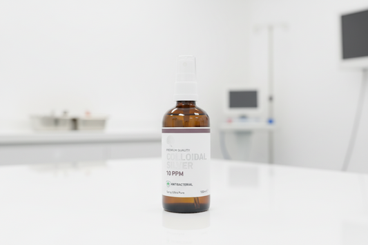 Bottle of colloidal silver solution with a label on a wooden surface.