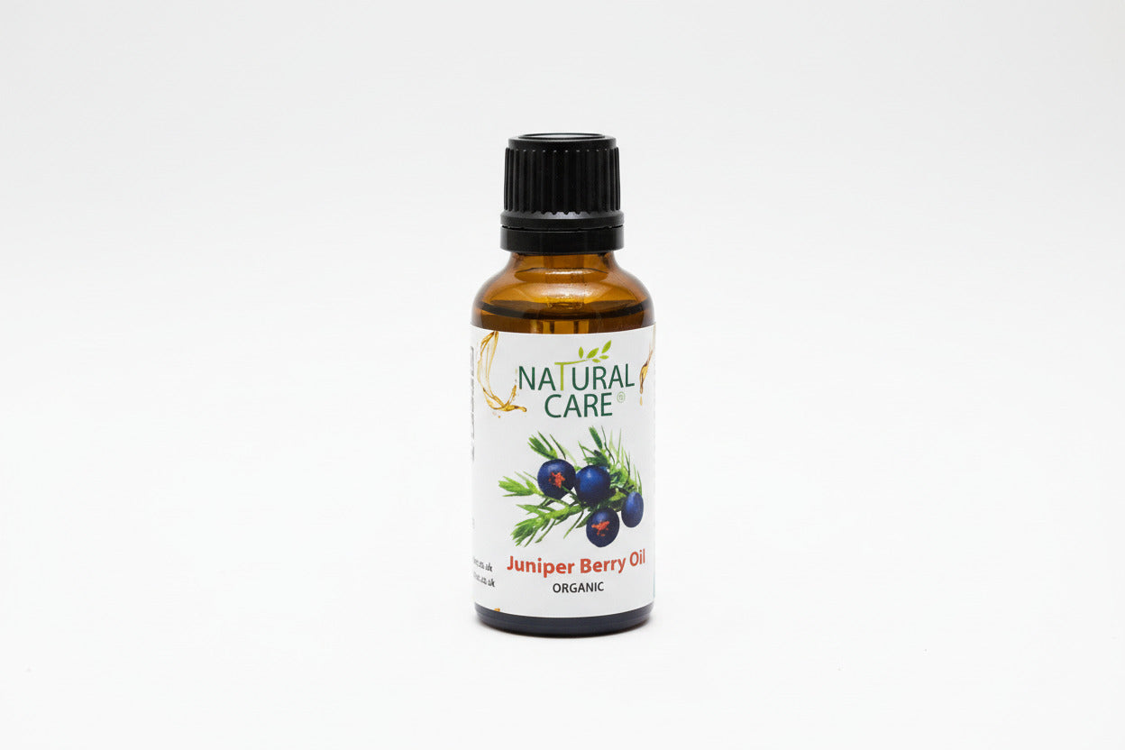 A bottle of Organic Juniperberry Essential Oil with a label showing the brand name, product name, and an image of juniper berries. The bottle is filled with a clear liquid.