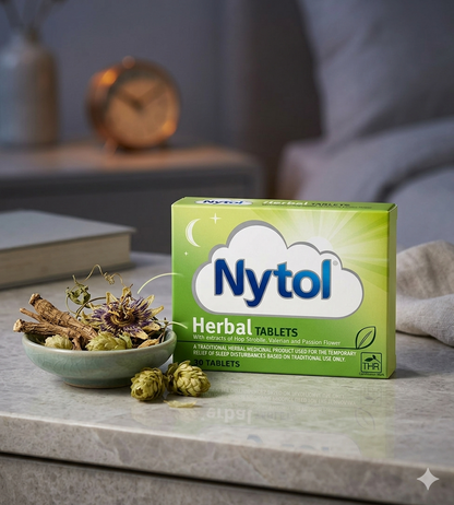 Nytol Herbal Tablets packaging on a table with herbs