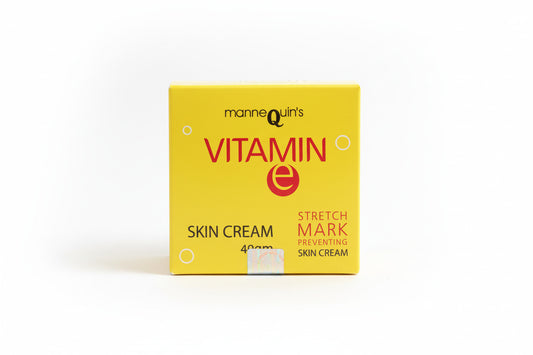 Yellow box of Mannequin's Vitamin E skin cream on a wooden surface