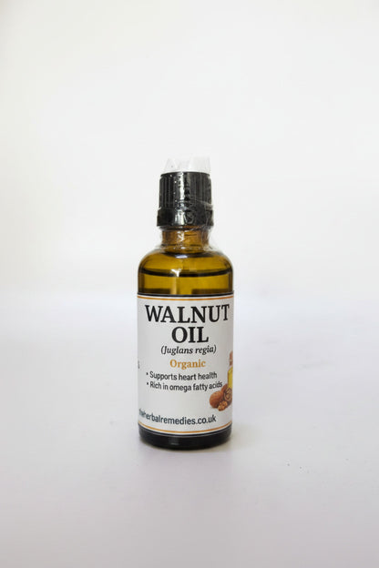Bottle of walnut oil with a label on a white background