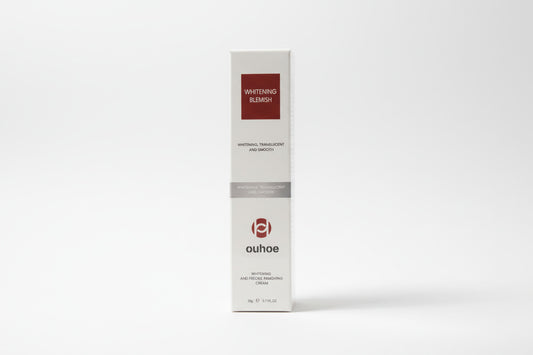 Ouhoe whitening blemish cream packaging with a scenic background
